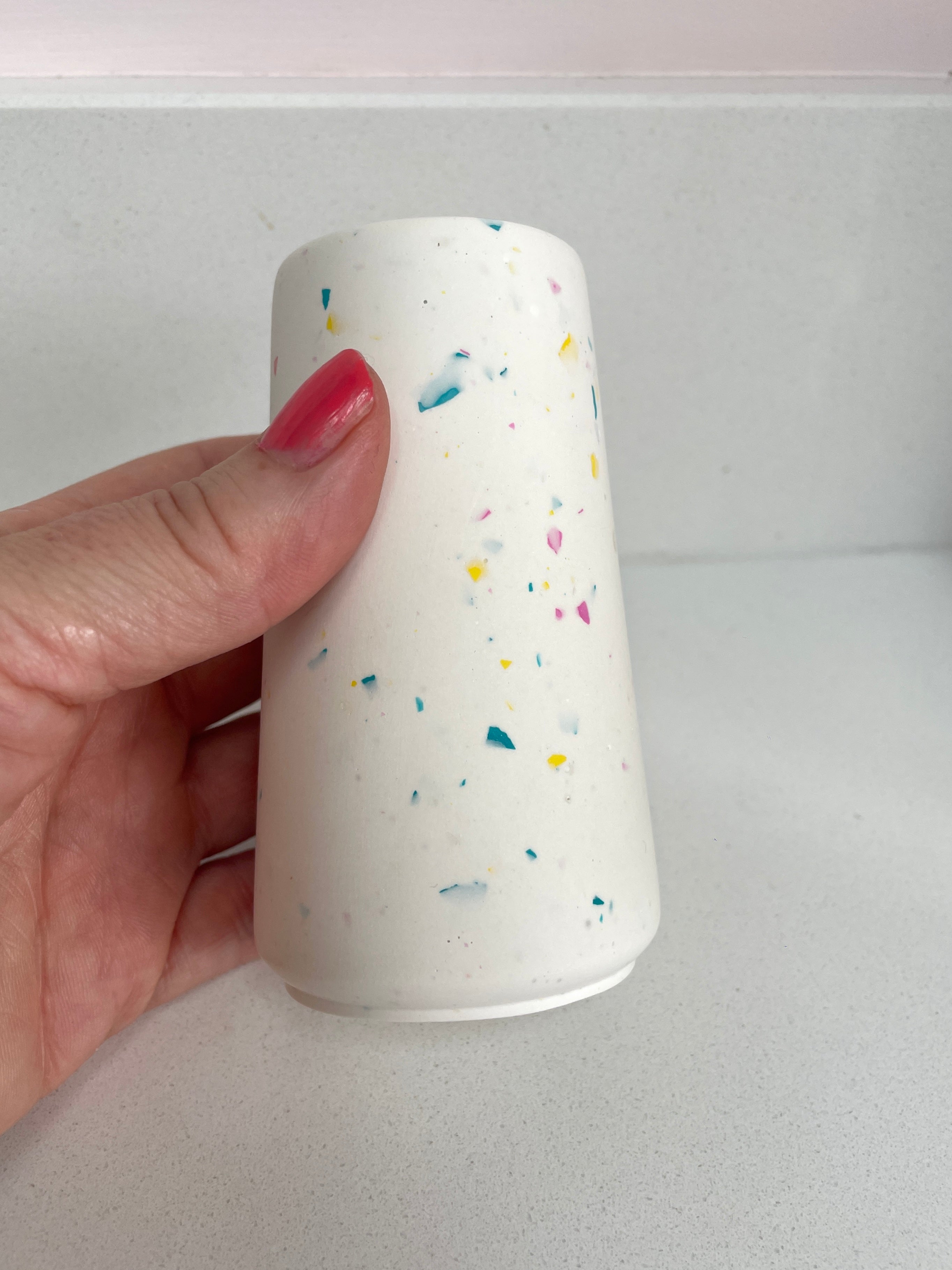 Tapered pot - white with pink, yellow and blue terrazzo chips.