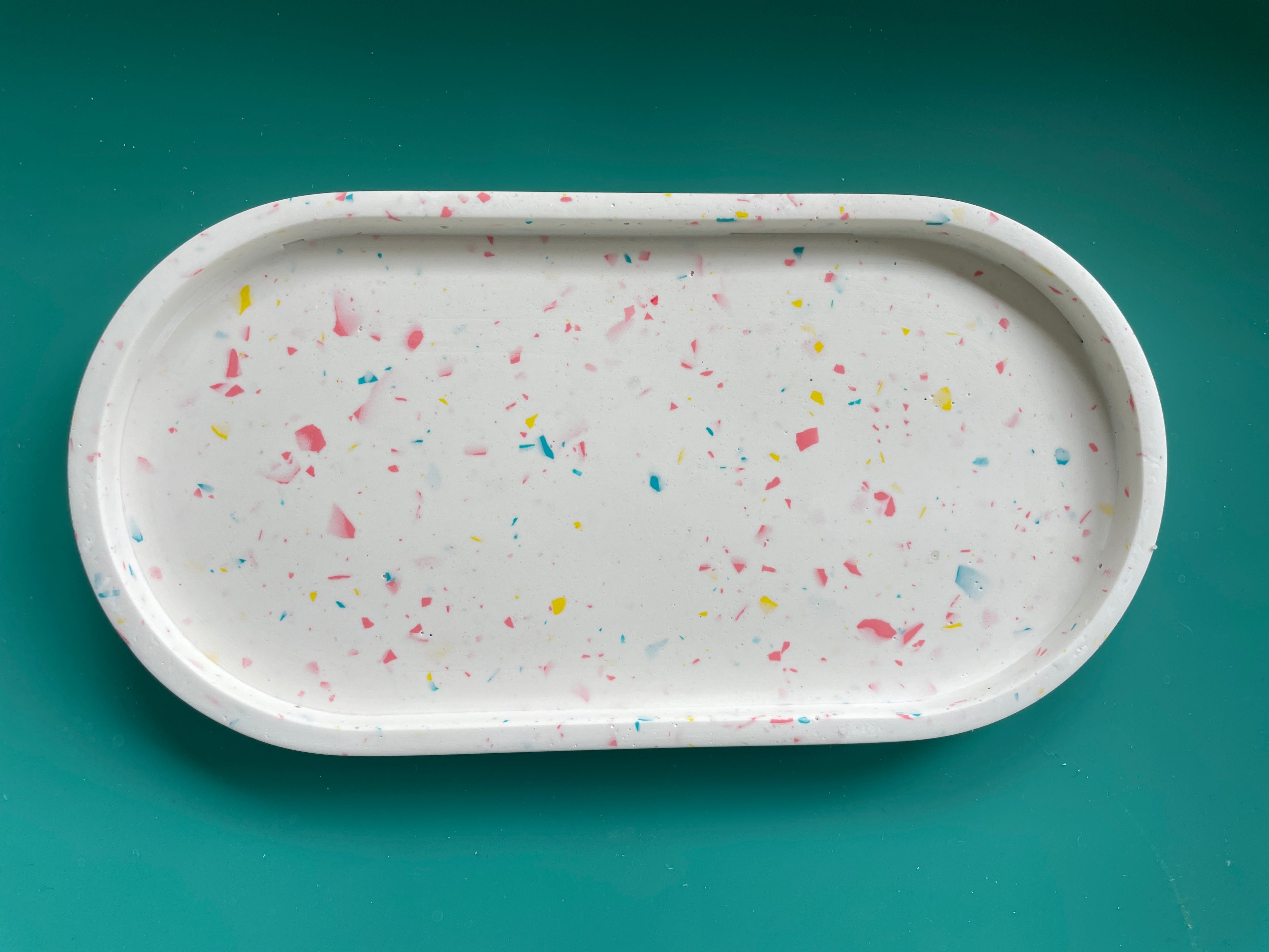 White oval tray with multicolour terrazzo chips.