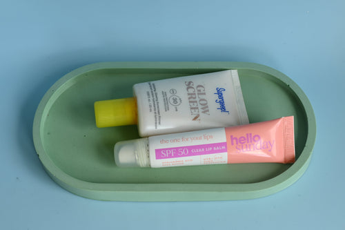 green oval tray with make-up on