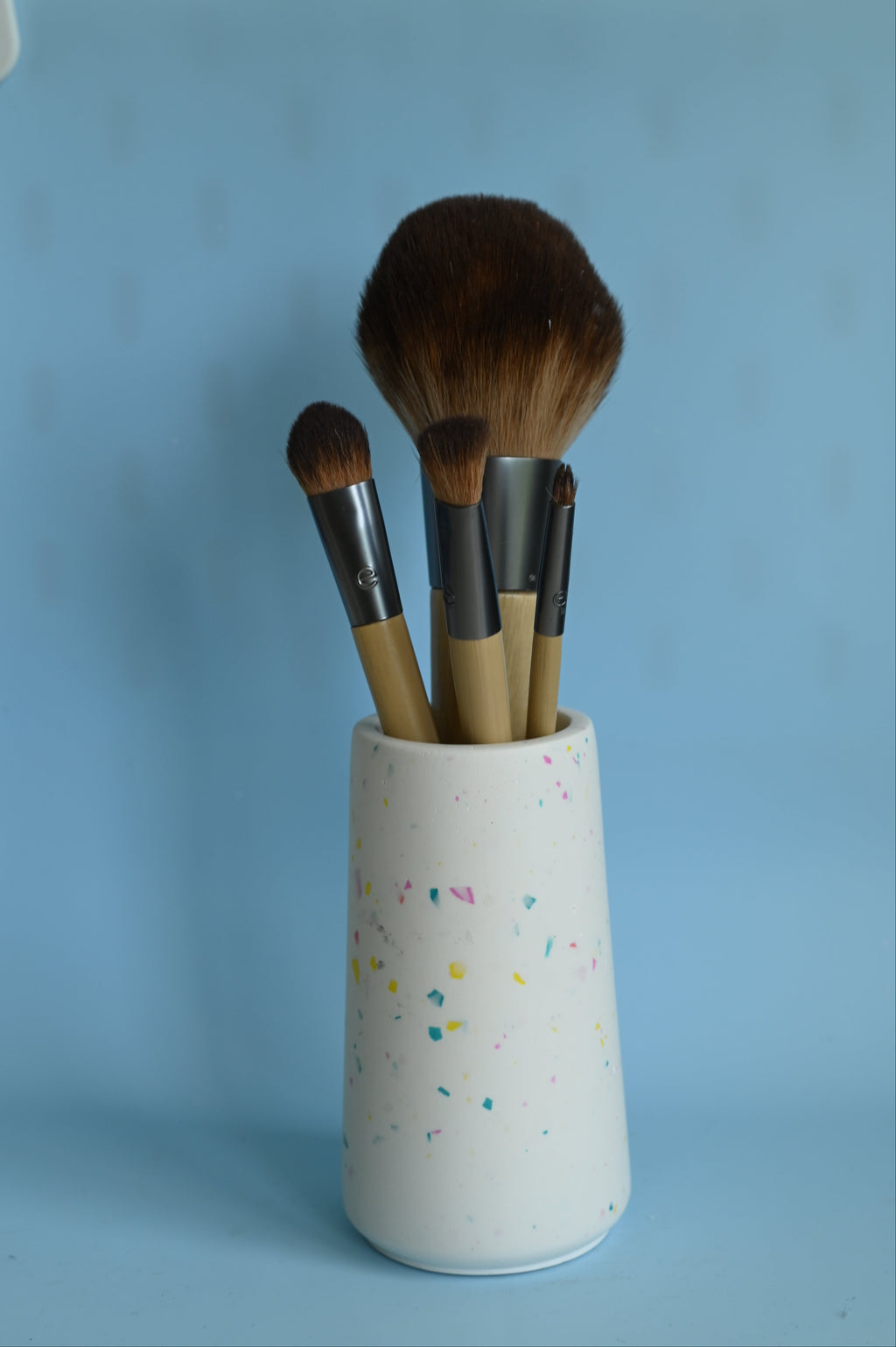 terrazzo pot with make-up brushes